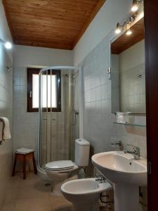 uma casa de banho com 2 lavatórios, um WC e um chuveiro em Casa Amizade B&B em Pedra Badejo