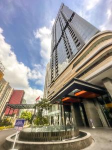 a tall building with a staircase in front of it at Grand Sungkono Lagoon Apartment 2BR Surabaya by Le Ciel Hospitality in Surabaya