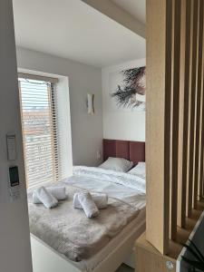 a bedroom with a bed with pillows and a window at TheOne - Apartament Księcia Witolda in Wrocław