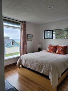a bedroom with a bed and a large window at Mendocino Art Center in Mendocino