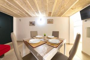 a dining room with a table and chairs at Baroque B&B in Lecce