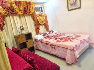 a bedroom with two beds and a window at Transient Home, an Affordable Bed & Bathroom near DVO Airport in Davao City