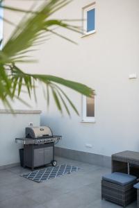 a grill sitting next to a white wall at A&V Residence in Novigrad Istria