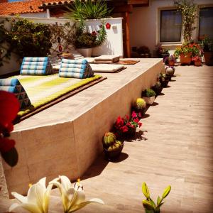 a patio with pillows and potted plants on it at B&B Domus de Janas Santa Teresa Gallura in Santa Teresa Gallura