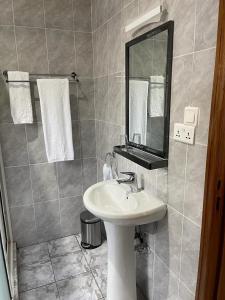 uma casa de banho com um lavatório e um espelho em Randa Boutique Hotel em Kigali