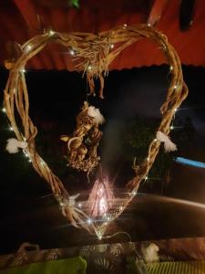 a heart made out of branches with a light at Eco Hostal Tierra de Agua y Fuego in San Rafael
