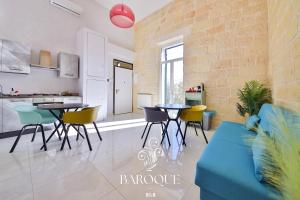 a kitchen and living room with a table and chairs at Baroque B&B in Lecce