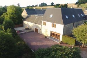 an aerial view of a white house with a garage at Domaine Des Hêtres in Longraye
