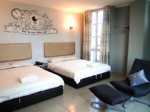 Postel nebo postele na pokoji v ubytování Angsana Hotel Melaka