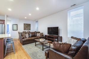 a living room with leather furniture and a flat screen tv at ENTIRE BUILDING-Walk to Lincoln Park or The Beach in Chicago