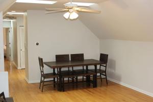 a dining room with a ceiling fan and a table and chairs at Lincoln Park Living - 3 Queen Beds - Sleeps 6 in Chicago