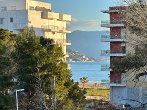 a tall building next to a body of water at Arial Lofts in Vlorë