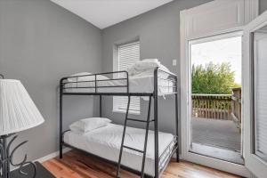 a bedroom with two bunk beds and a balcony at 713a - Settle in Historic Soulard in Soulard