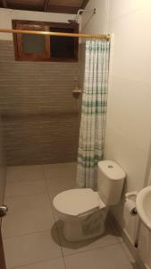a bathroom with a toilet and a shower at Finca Hotel La Estancia in Santa Fe de Antioquia