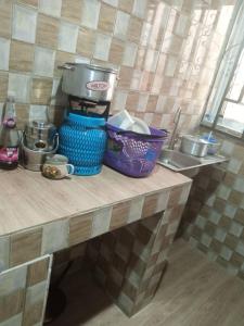 a kitchen counter with pots and pans on it at Tradebybata Homes, Abeokuta around FUNAAB in Abeokuta