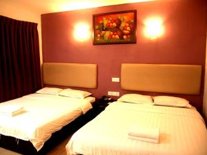Postel nebo postele na pokoji v ubytování Angsana Hotel Melaka