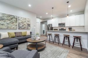 a living room with a couch and a kitchen at 2 New Construction Suites Same Place in Chicago