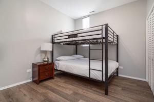 a bedroom with a bunk bed and a night stand at 2 New Construction Suites Same Place in Chicago