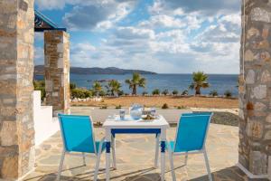 a table and chairs with a view of the ocean at Sea View Studios in Finikas