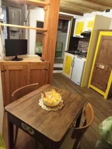 a wooden table with a bowl of food on it at Domy CENTRAL STUDIO in Aosta