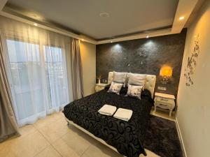 1 dormitorio con cama negra y ventana grande en Apartamento Amposta, en Salou