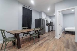 a room with a table and chairs and a bed at MTM Fully Furnished Rental in Old Town - 2 beds in Chicago