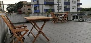 a wooden table and chairs sitting on a roof at Rooms São Dinis in Porto