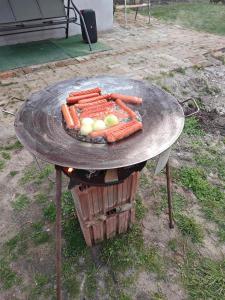 a grill with carrots and other vegetables on it at Skylark Relax Apartman in Szeged