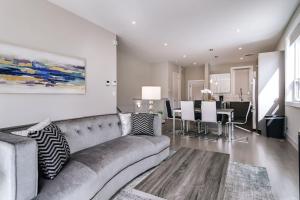 a living room with a couch and a dining room at Stunning Duplex Condo #1 - Downtown River North in Chicago