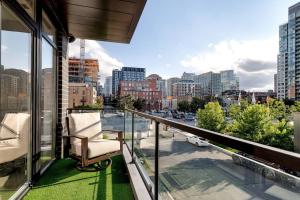 a balcony with chairs and a view of a city at Stunning Condo #2 - Downtown River North in Chicago