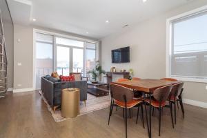 a living room with a table and a couch at Breathtaking Downtown Penthouse A - Sleeps 11 in Chicago