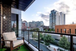 a balcony with a chair and a view of a city at Breathtaking Downtown Penthouse A - Sleeps 11 in Chicago