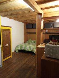 a bedroom with a bed in a room with wooden ceilings at Domy CENTRAL STUDIO in Aosta