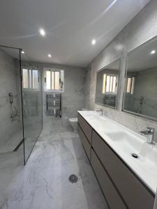 a bathroom with a tub and a sink and a shower at La Manga Club Resort - 3 bedroom Duplex - La Colina in Atamaría