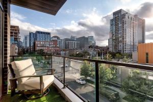 a balcony with a chair and a view of a city at New Construction Building in River North in Chicago