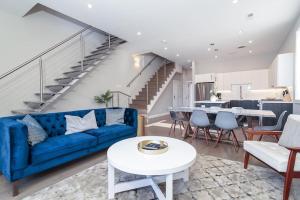 a living room with a blue couch and a table at New Construction Building in River North in Chicago