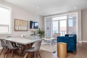 a living room with a dining room table and chairs at New Construction Building in River North in Chicago