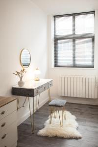 a room with a desk and a mirror and a stool at Cityscape 2-BR - Leicester's Premier Urban Retreat in Leicester