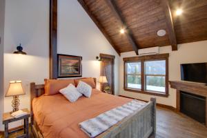 a bedroom with a large bed and a tv at Dazzling Cle Elum Home with Game Room and Fire Pit! in Ronald