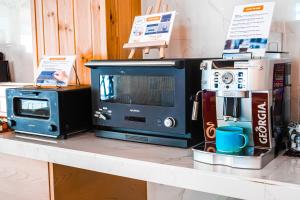 a counter top with a microwave and a microwave at Hotel Imagine Kyoto in Kyoto