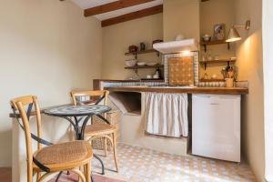 cocina con encimera, mesa y sillas en Hotel La Casa del Califa, en Vejer de la Frontera