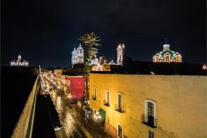 a view of a city at night with lights at OYO Hotel Casona Poblana in Puebla