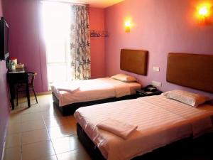 Postel nebo postele na pokoji v ubytování Angsana Hotel Melaka