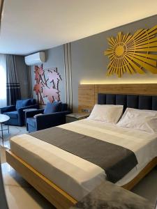 a bedroom with a large bed and a living room at Midyat GAP Hotel in Midyat