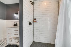 a bathroom with a shower with white subway tiles at Suttons Bay Home In Town - 2 Blocks to Beach! in Suttons Bay +23 photos