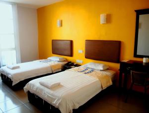 Postel nebo postele na pokoji v ubytování Angsana Hotel Melaka