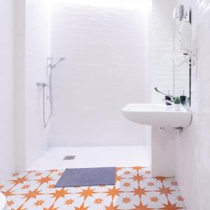 a white bathroom with a sink and a toilet at BILBAO NORTH SHORE APARTMENTS 2 in Bilbao