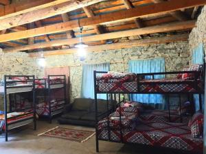 a room with four bunk beds and a couch at Panorama guesthouse Mata C. in Adishi