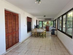 a room with a table and chairs in a house at Espectacular casa quinta al río! in Sauce Viejo