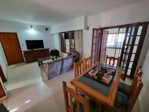 a living room with a table and a dining room at Espectacular casa quinta al río! in Sauce Viejo